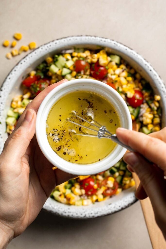 Whisking lime dressing for avocado corn salad.