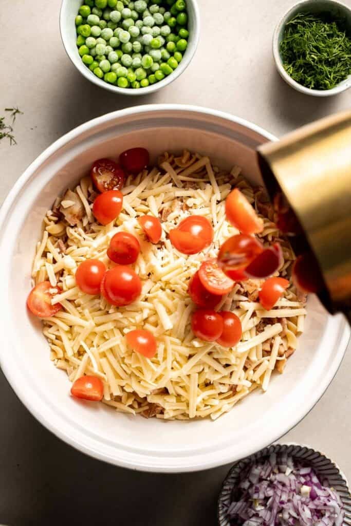 Cherry tomatoes added to bacon ranch pasta salad ingredients.