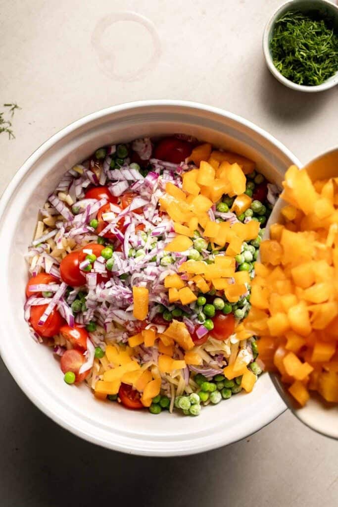 Diced orange bell pepper added to the pasta salad.