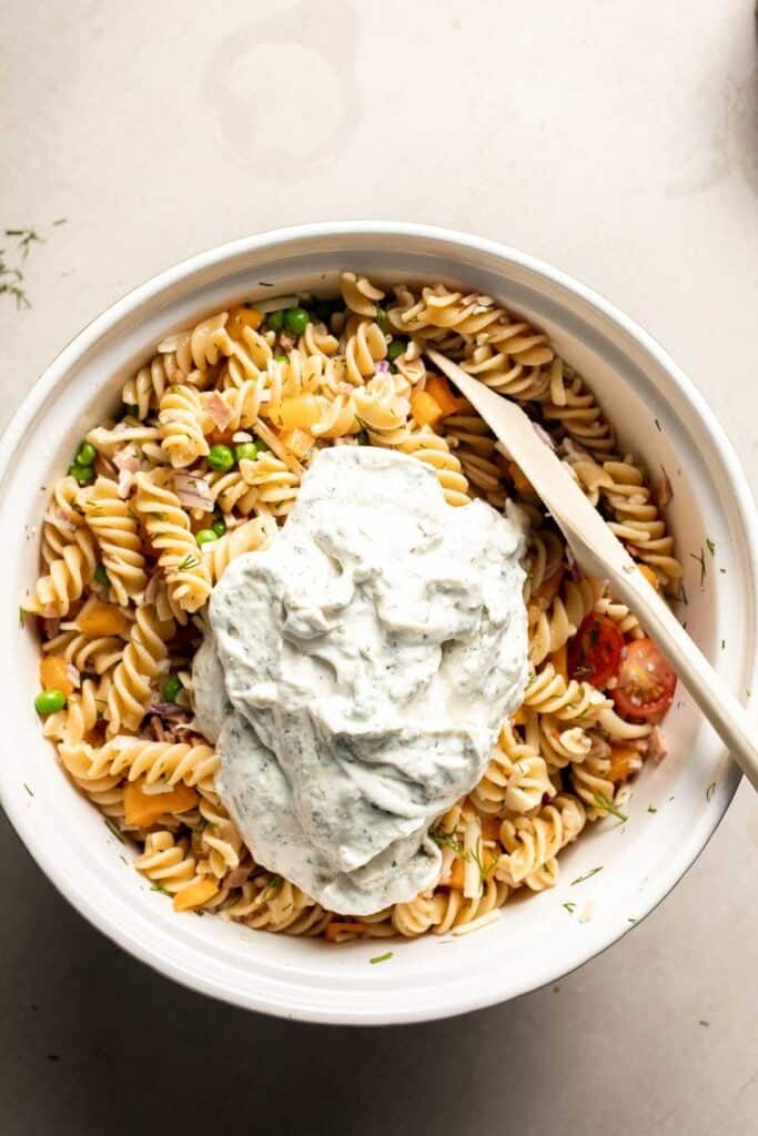 Ranch dressing added to pasta salad before mixing.