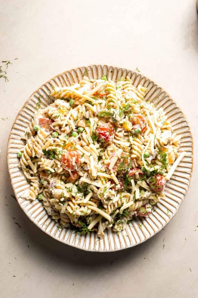 Overhead view of bacon ranch pasta salad with bacon, cheddar cheese, vegetables, and ranch dressing.