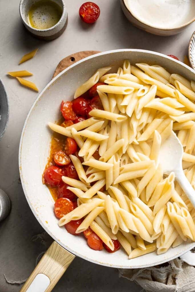Pasta tossed with softened tomatoes and reserved pasta water.