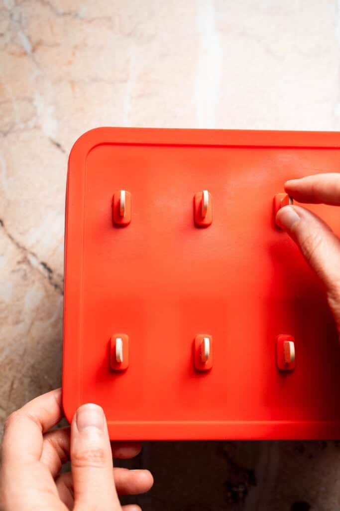 Popsicle sticks inserted into fudgesicle molds.
