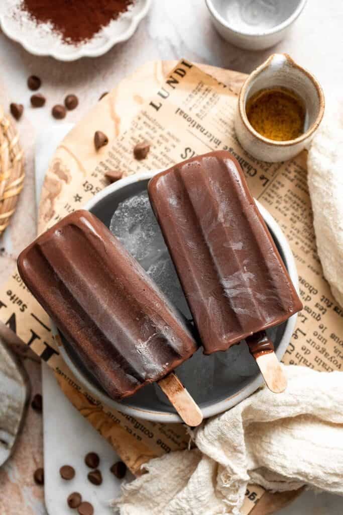 Homemade fudgesicles made with real chocolate served on a plate.
