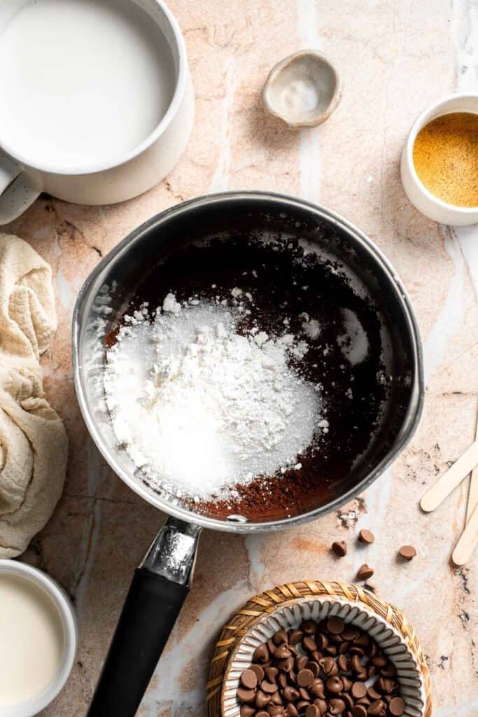 Sugar, cocoa powder, cornstarch, and salt added to a saucepan.