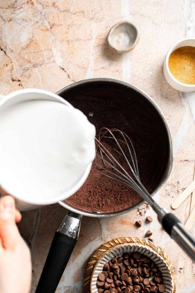 Milk being poured into the chocolate mixture.