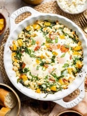Mediterranean baked eggs with feta and tomatoes, spinach, bell peppers, and baked eggs in a one-pan breakfast dish.