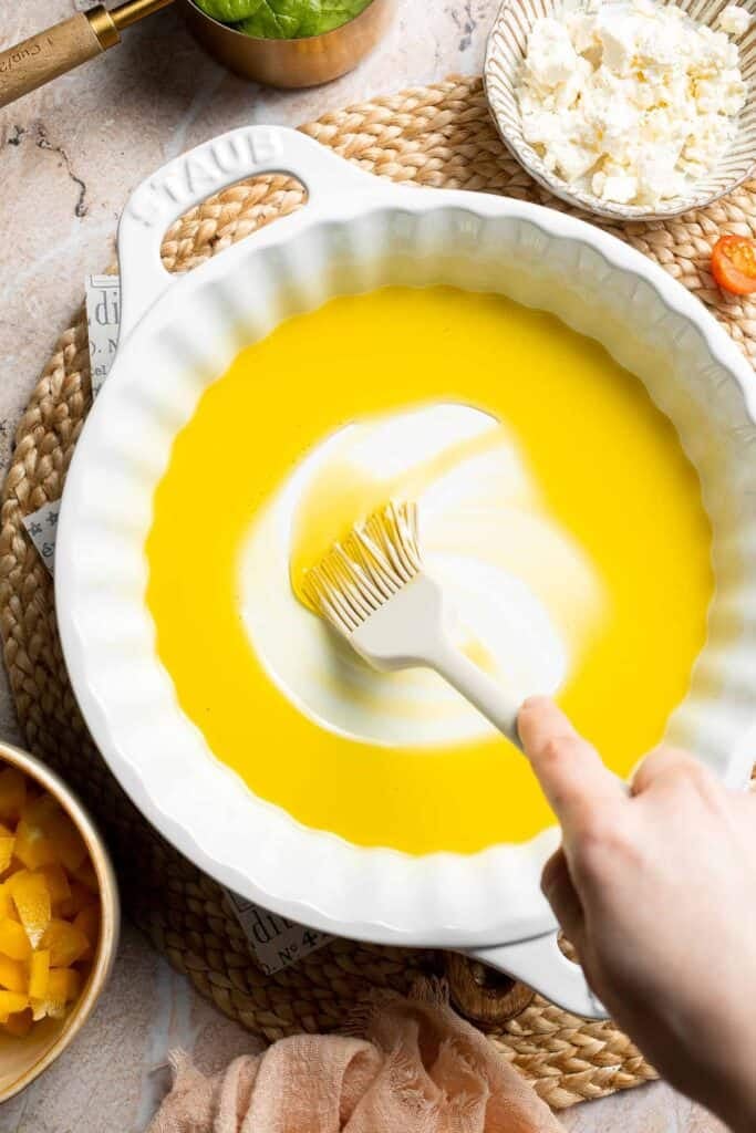Olive oil brushed evenly around a baking dish.