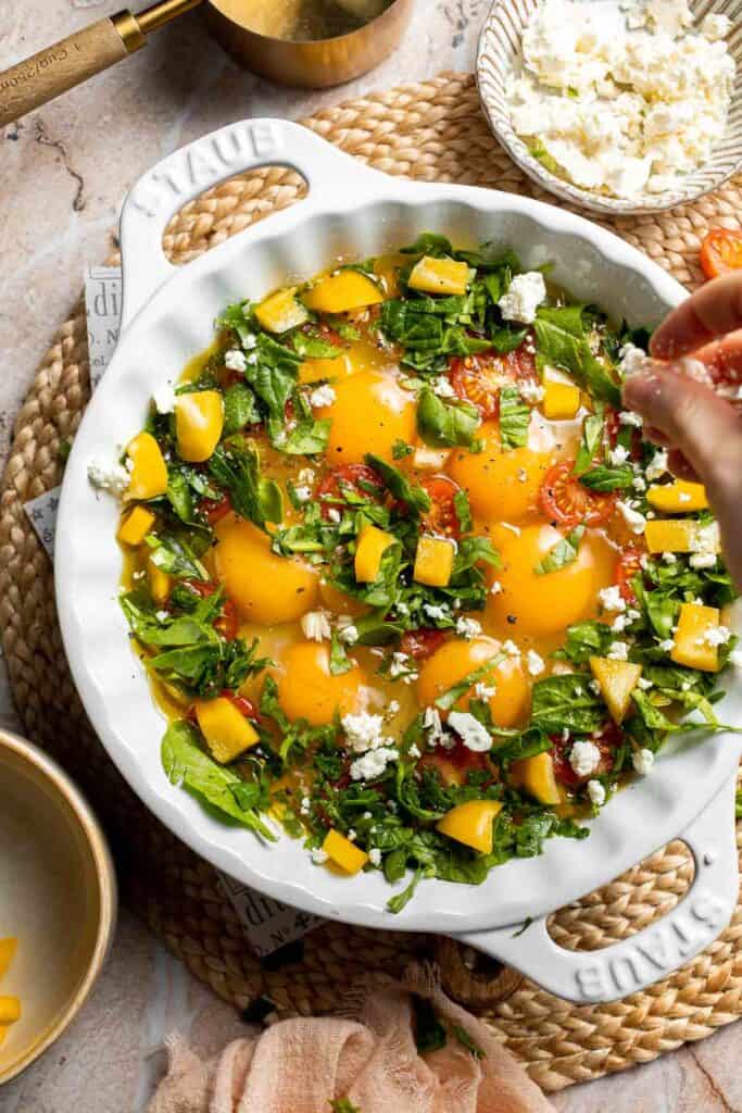 Mediterranean baked eggs seasoned and ready for feta cheese.