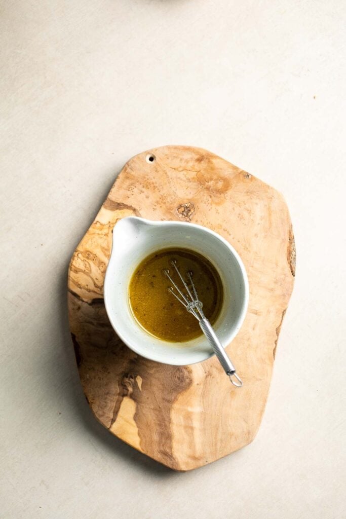 Homemade vinaigrette for panzanella salad in a small bowl