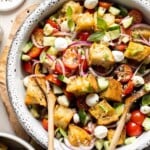 Panzanella salad (Italian bread salad) with toasted bread, tomatoes, cucumber, mozzarella, and basil