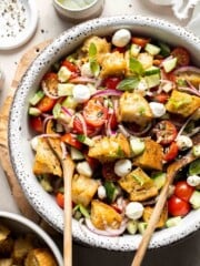 Panzanella salad (Italian bread salad) with toasted bread, tomatoes, cucumber, mozzarella, and basil