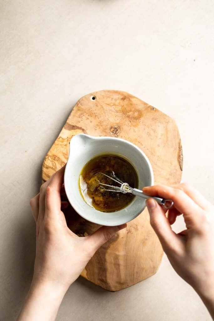 Whisking homemade vinaigrette for panzanella salad