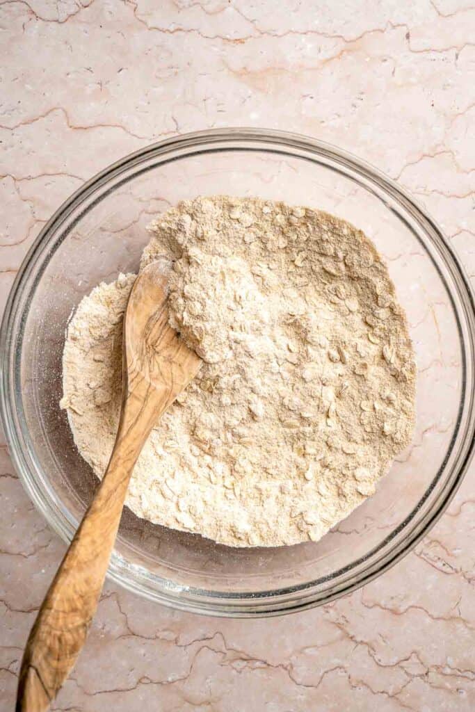 Dry ingredients for the buttery oat crumble topping in a mixing bowl.