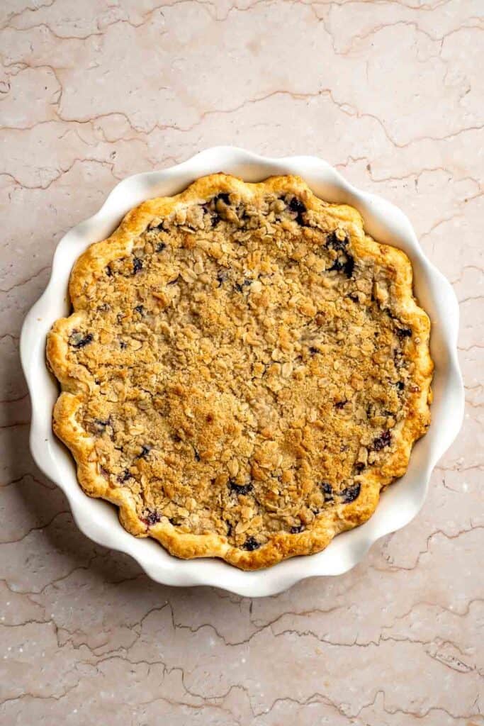 Freshly baked blueberry crumble pie with a golden brown oat topping.