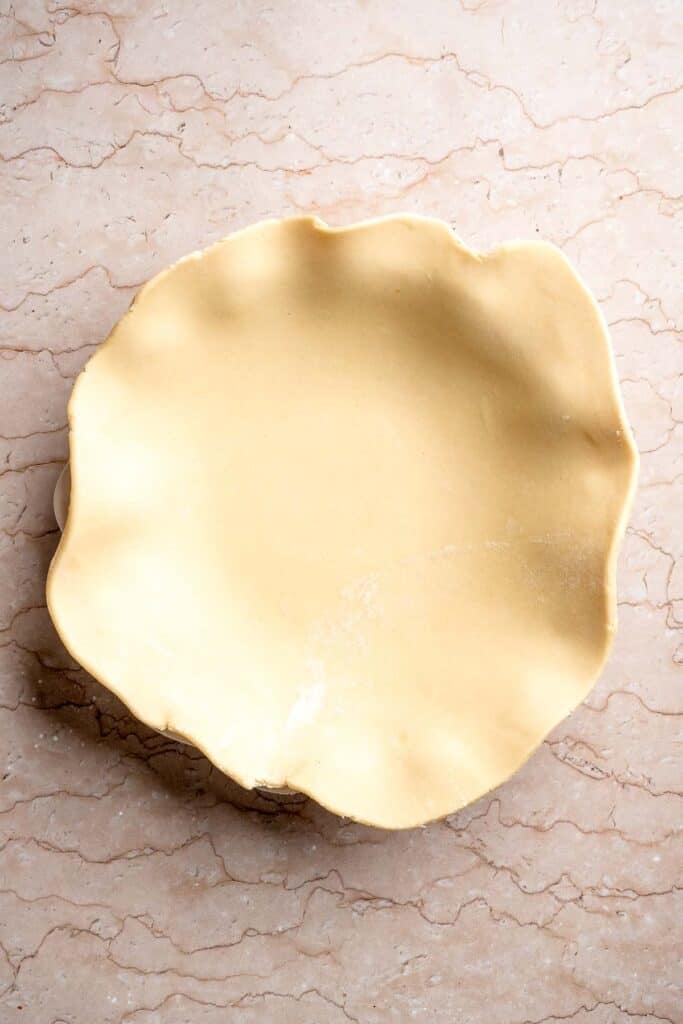 Pie dough pressed into a 9-inch pie dish before filling.