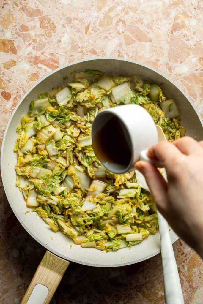 hinese Cabbage Stir Fry finished cooking in a skillet with sesame oil.