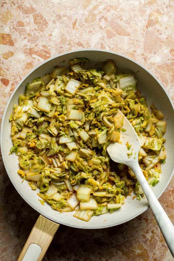 Chinese Cabbage Stir Fry served in a skillet with soy sauce and sesame oil.