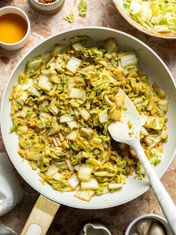 Chinese Cabbage Stir Fry served in a skillet with soy sauce and sesame oil.