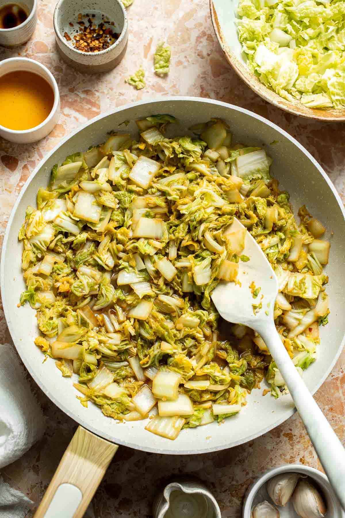 Chinese Cabbage Stir Fry served in a skillet with soy sauce and sesame oil.