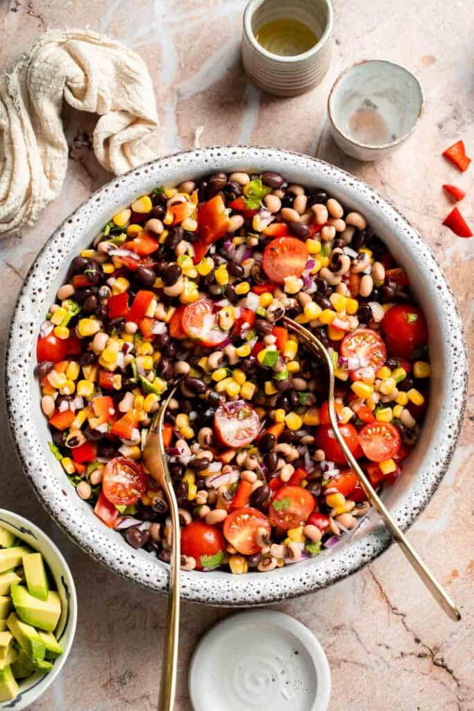 Fresh Cowboy Caviar mixed together with black beans, corn, tomatoes, peppers, and herbs.