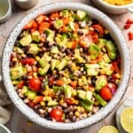 Fresh Cowboy Caviar made with black beans, black-eyed peas, corn, avocado, tomatoes, and a zesty lime dressing.
