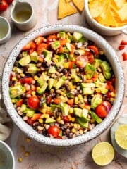 Fresh Cowboy Caviar made with black beans, black-eyed peas, corn, avocado, tomatoes, and a zesty lime dressing.