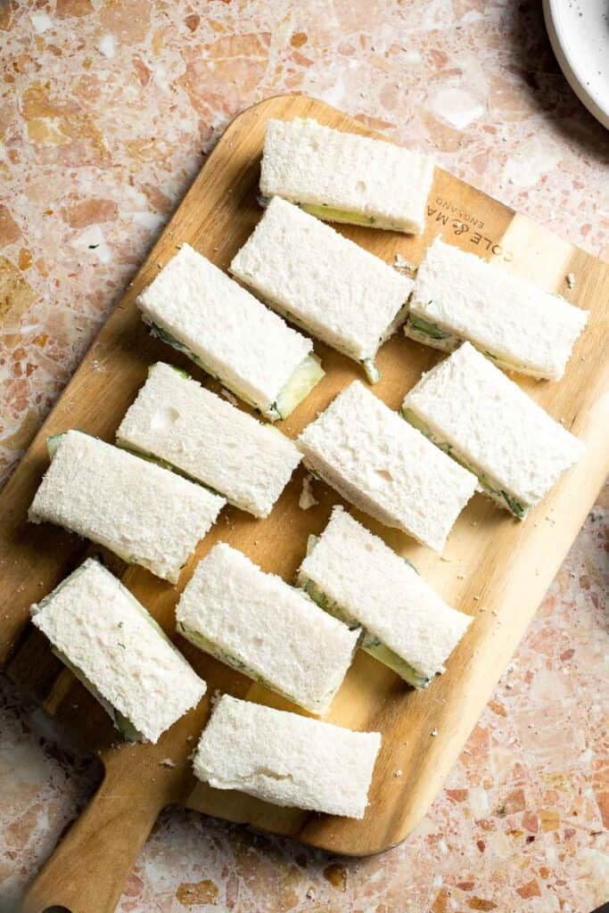 Cucumber Tea Sandwiches arranged on a serving plate with fresh dill.