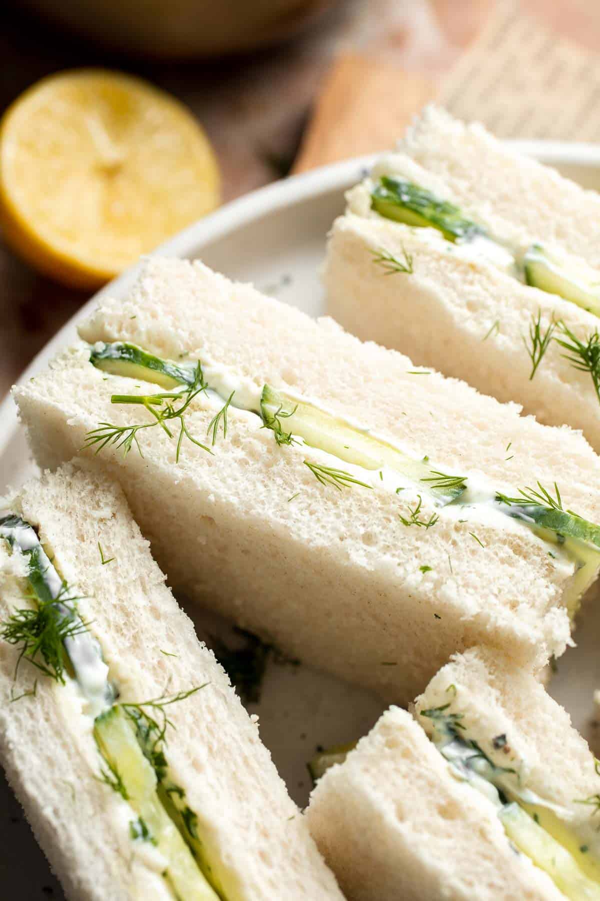 Close-up of Cucumber Tea Sandwiches showing layers of soft white bread, cucumber, and creamy dill and chive filling.
