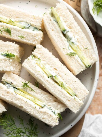 Cucumber Tea Sandwiches arranged on a serving plate with creamy herb filling, thinly sliced English cucumber, and fresh dill.