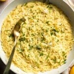 Creamy Lemon Orzo made with Parmesan cheese, fresh lemon, garlic, and parsley in a skillet.