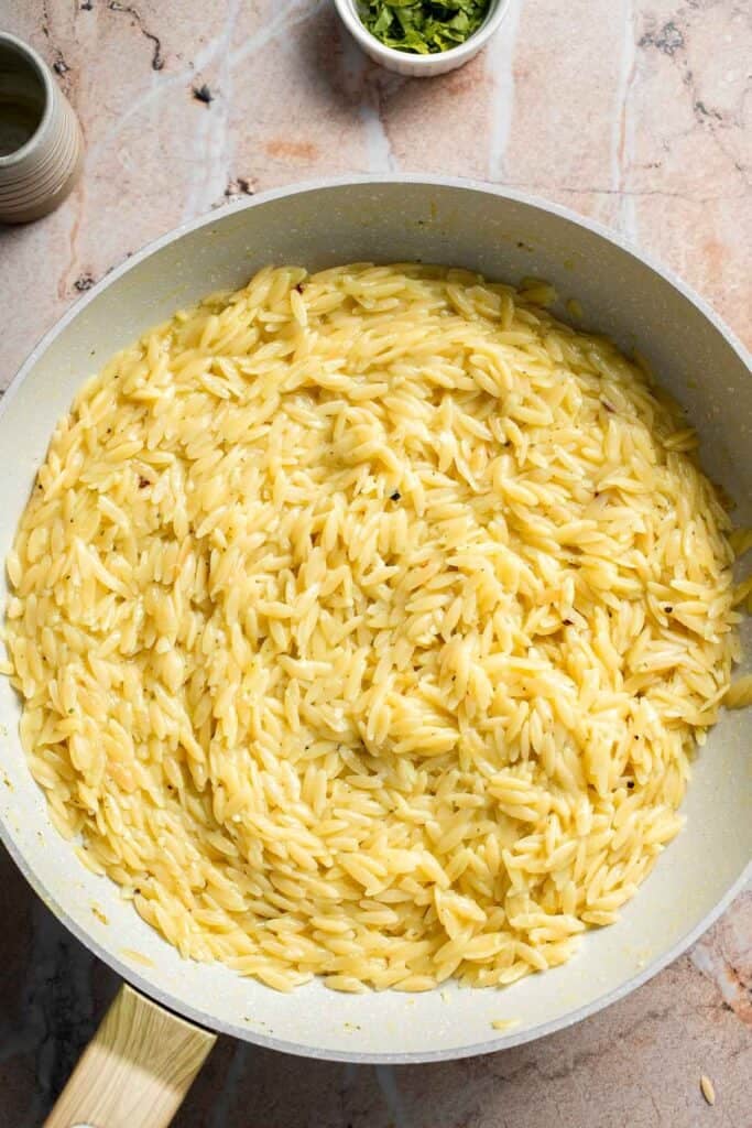 Creamy Lemon Orzo finished cooking in a skillet.