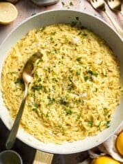 Creamy Lemon Orzo made with Parmesan cheese, fresh lemon, garlic, and parsley in a skillet.