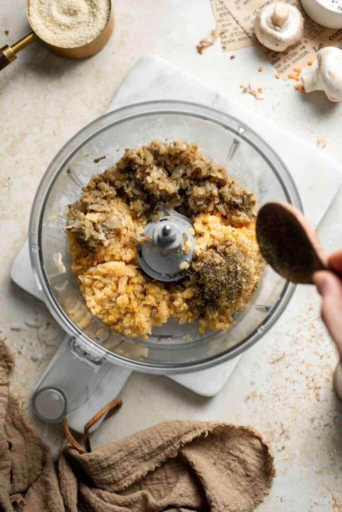 Cooked red lentils and mushroom mixture combined in a food processor.