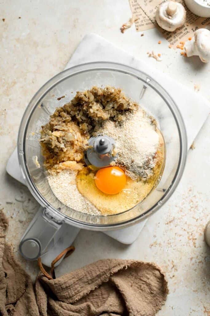 Adding an egg to the red lentil patty mixture.