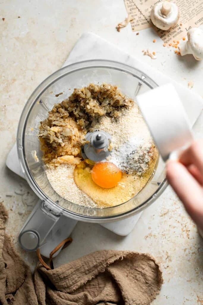Seasoning the lentil patty mixture with salt and pepper.