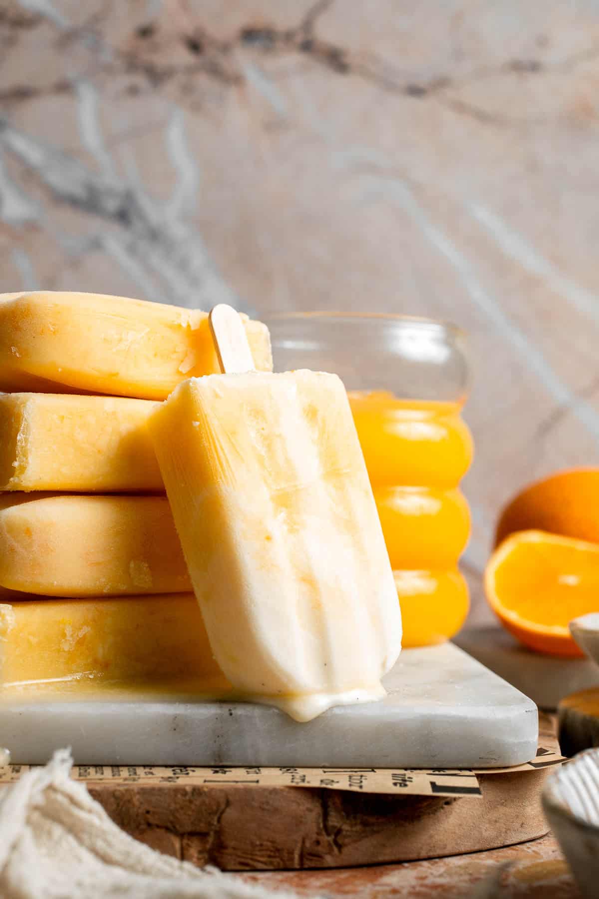 Close up of homemade Orange Creamsicles with orange and vanilla cream swirls.