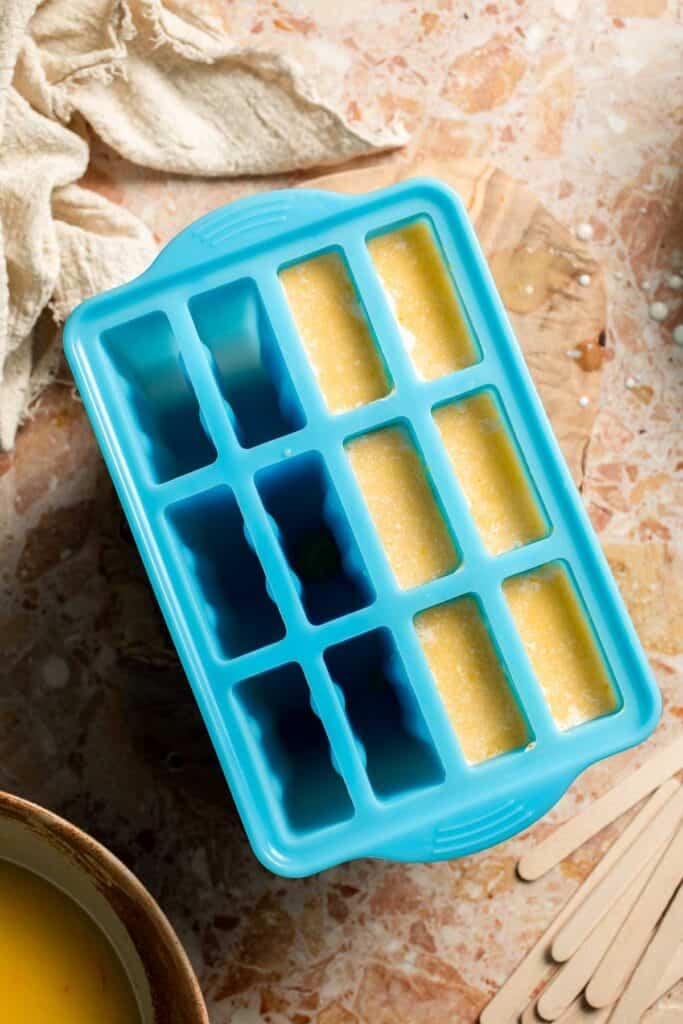 Orange and vanilla cream layers filling a popsicle mold.