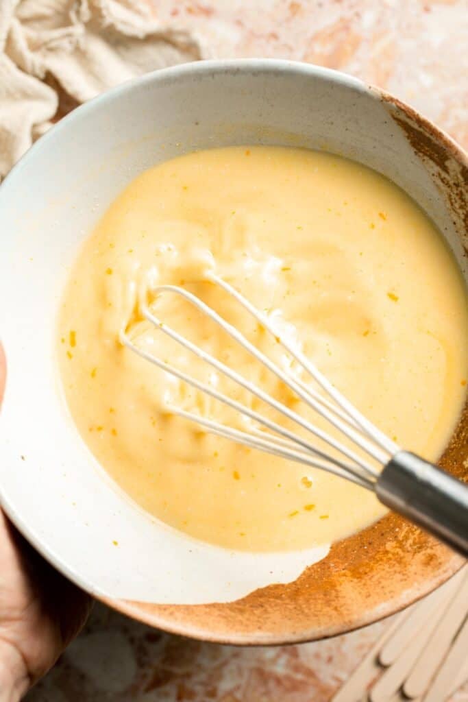 Whisking the orange and cream mixtures together for uniform Orange Creamsicles.