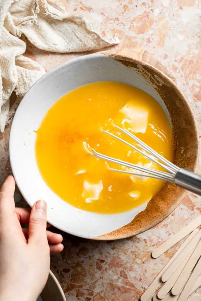 Whisking the orange juice, orange zest, and Greek yogurt together.