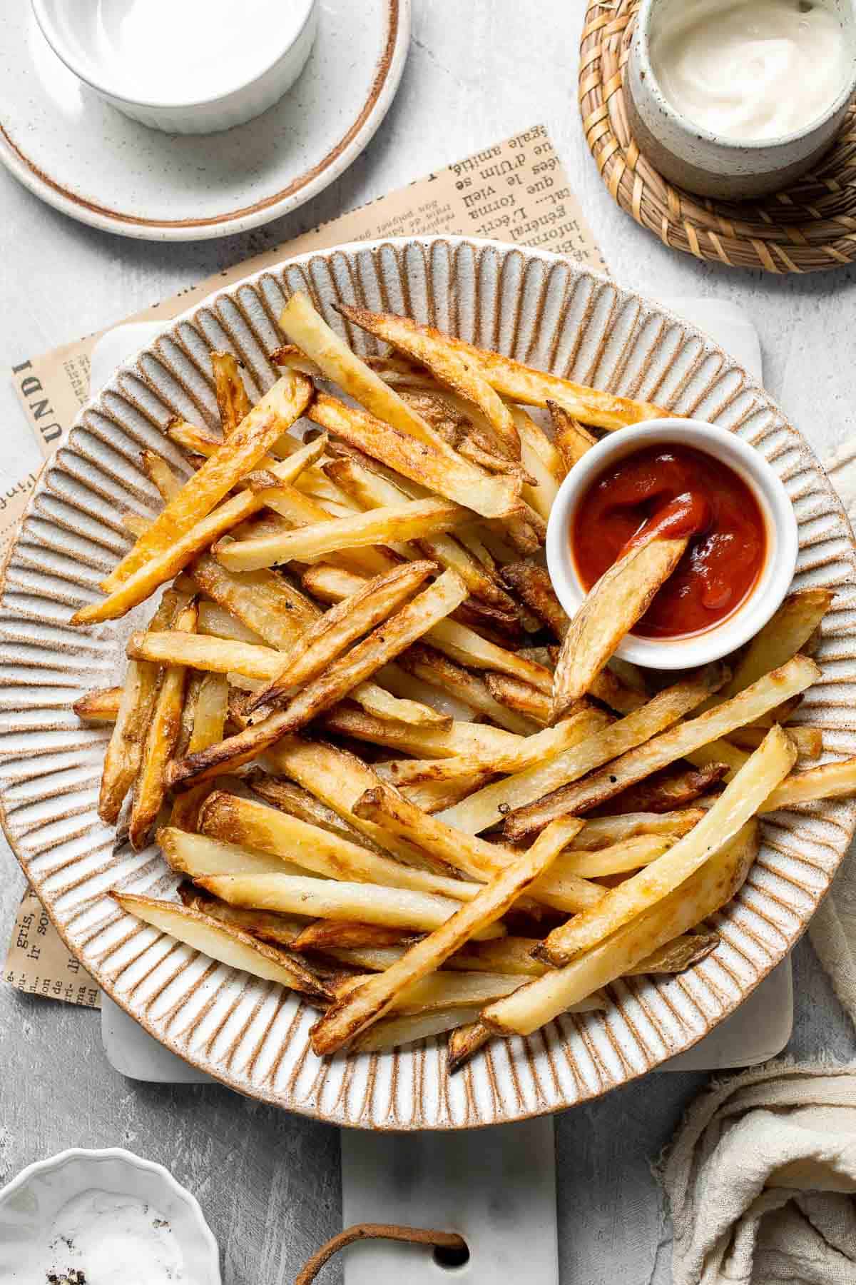 Bowl of homemade French fries with crispy golden edges.