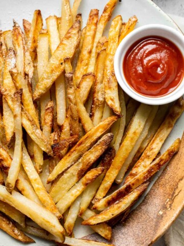 Oven Baked French Fries with crispy golden edges served with ketchup.