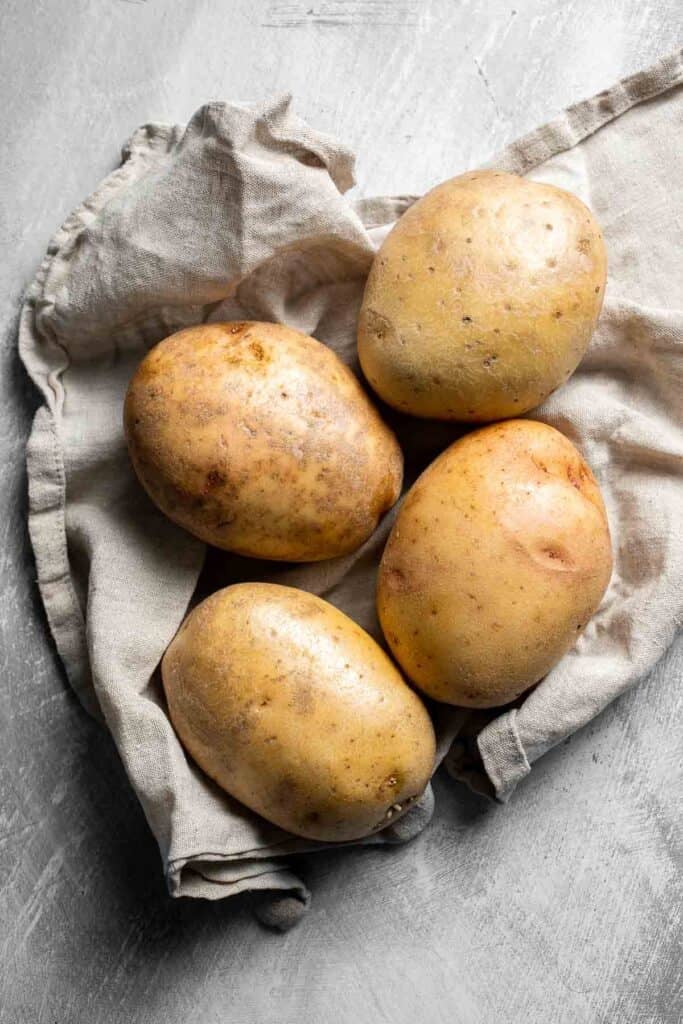 Whole russet potatoes ready to make oven baked French fries.