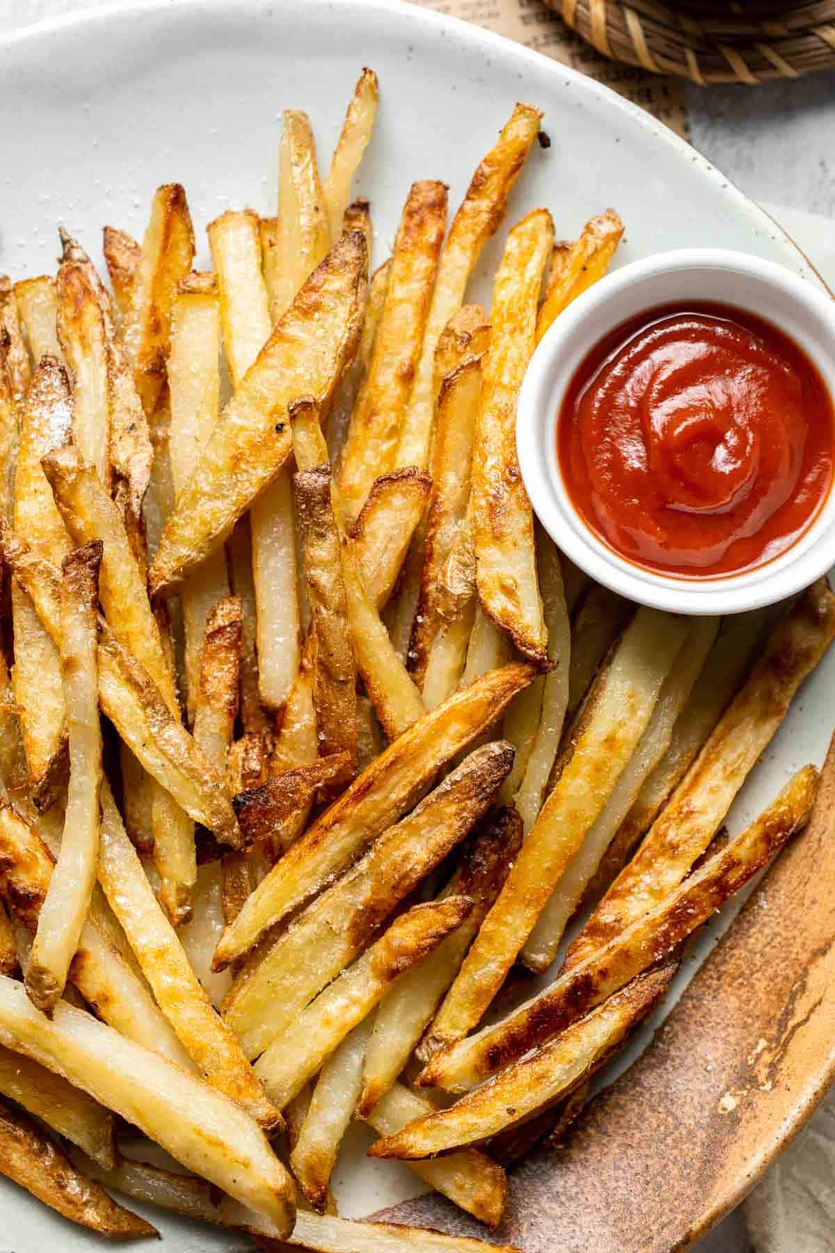 Oven Baked French Fries with crispy golden edges served with ketchup.