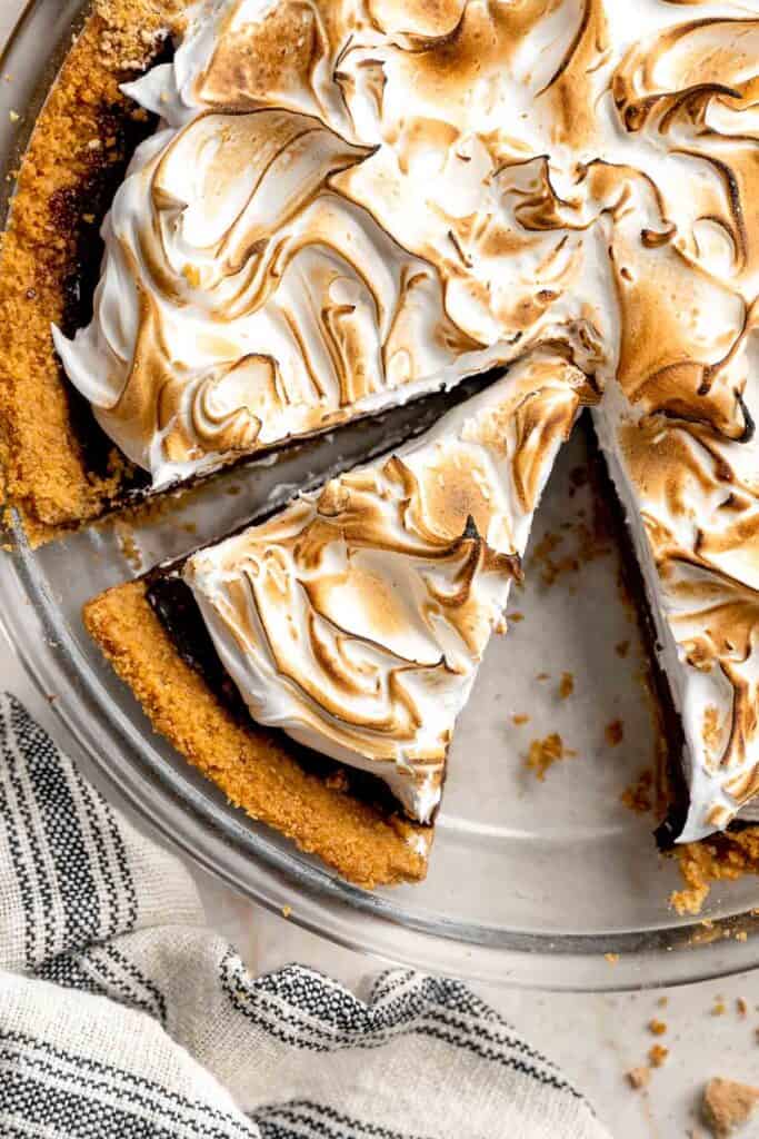 Close-up of sliced S'mores Pie with layers of graham cracker crust, chocolate ganache, and toasted marshmallow.