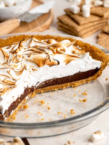 S'mores Pie with layers of buttery graham cracker crust, rich chocolate ganache, and fluffy toasted marshmallow topping.