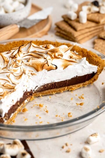 S'mores Pie with layers of buttery graham cracker crust, rich chocolate ganache, and fluffy toasted marshmallow topping.