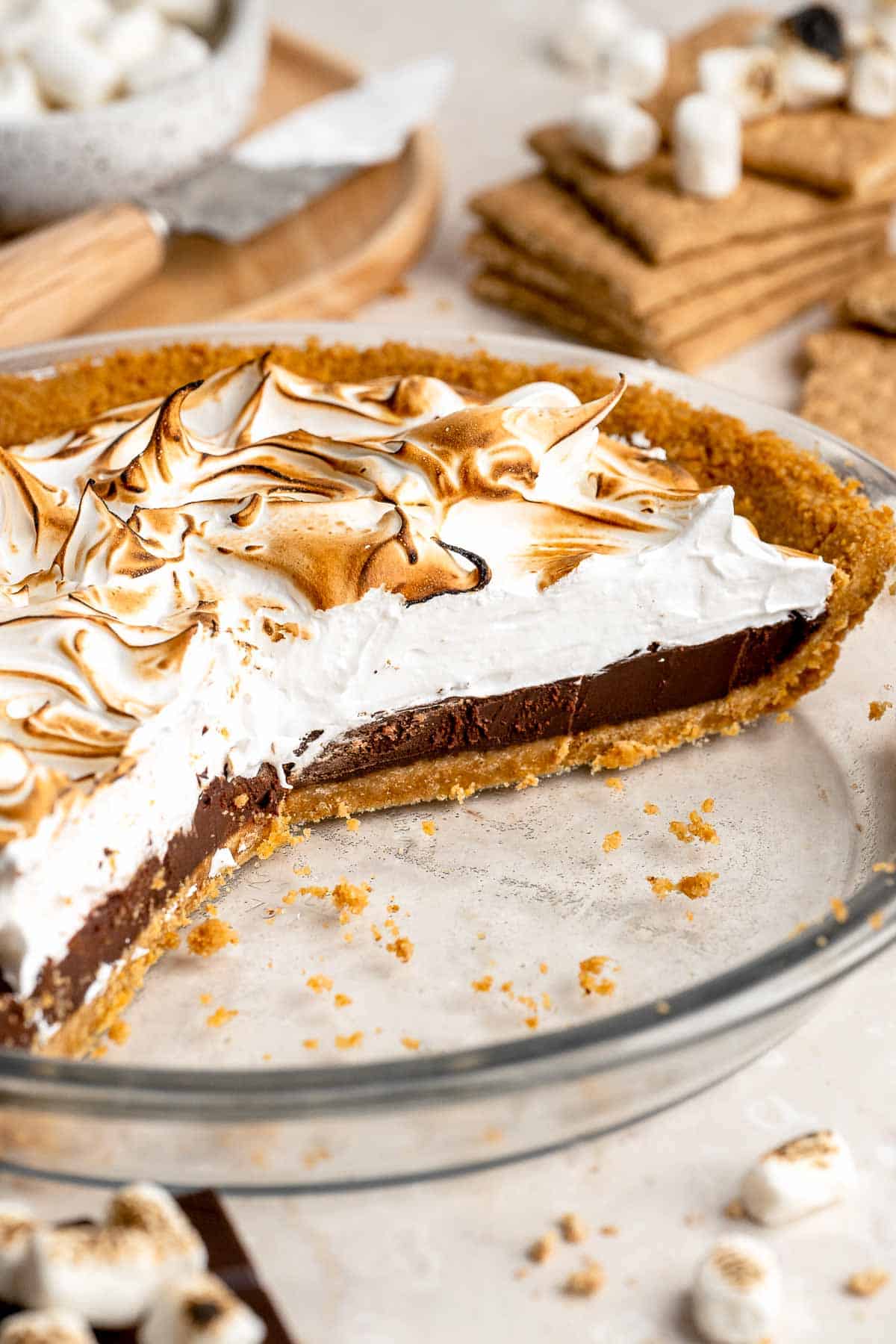 S'mores Pie with layers of buttery graham cracker crust, rich chocolate ganache, and fluffy toasted marshmallow topping.