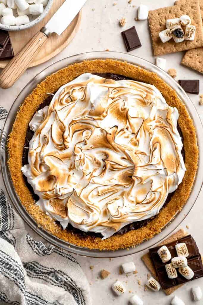 Finished S'mores Pie with toasted marshmallow topping, graham cracker crust, and chocolate ganache filling.