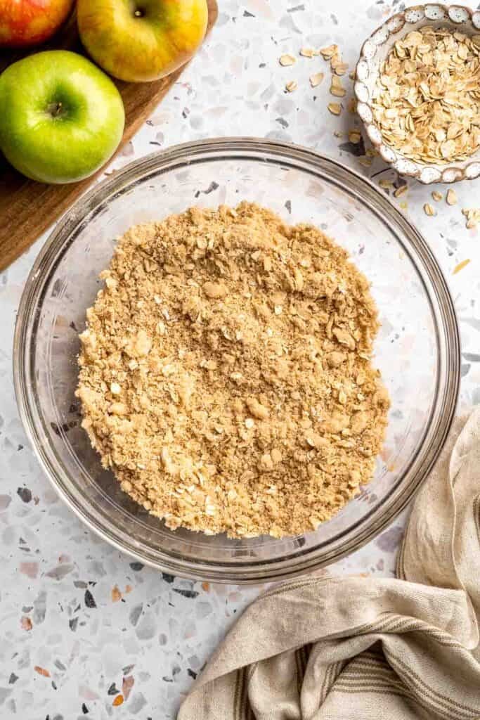 Finished crumble topping with coarse, pea-sized crumbs in a glass bowl